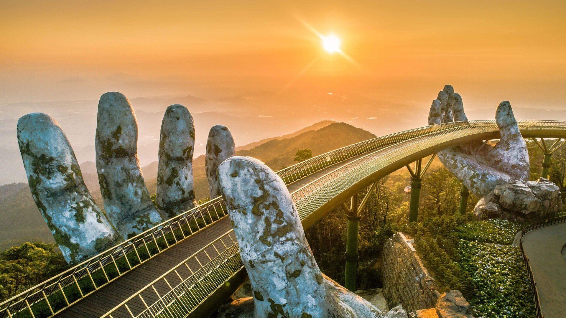 An aerial view of a bridge with giant hands on it.