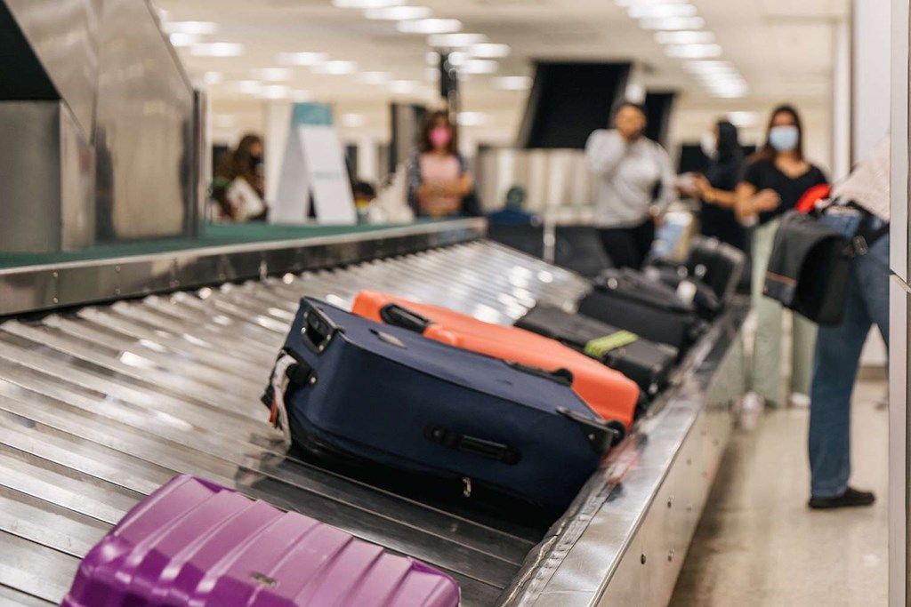 Passenger reporting lost baggage at airport counter