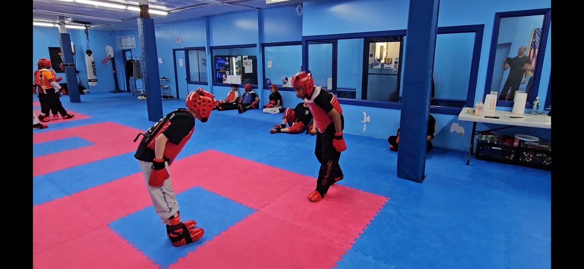 Kids practice safe partner drills at Universal Mixed Martial Arts in South Richmond Hill, NY.