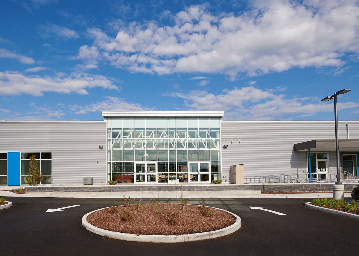 A large building with a circular driveway in front of it