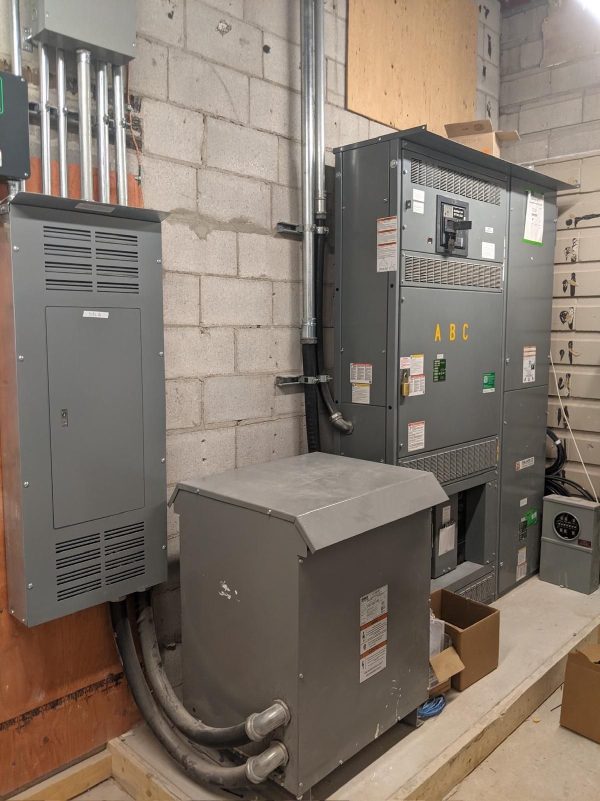 A room with a lot of electrical equipment on the wall.