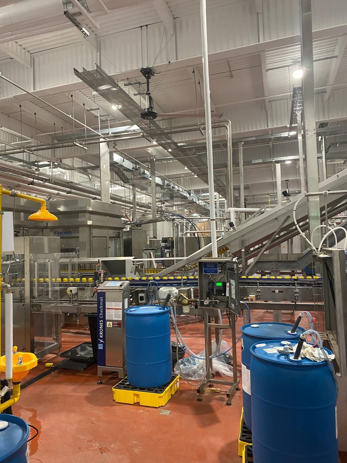 A factory filled with lots of barrels and machinery.