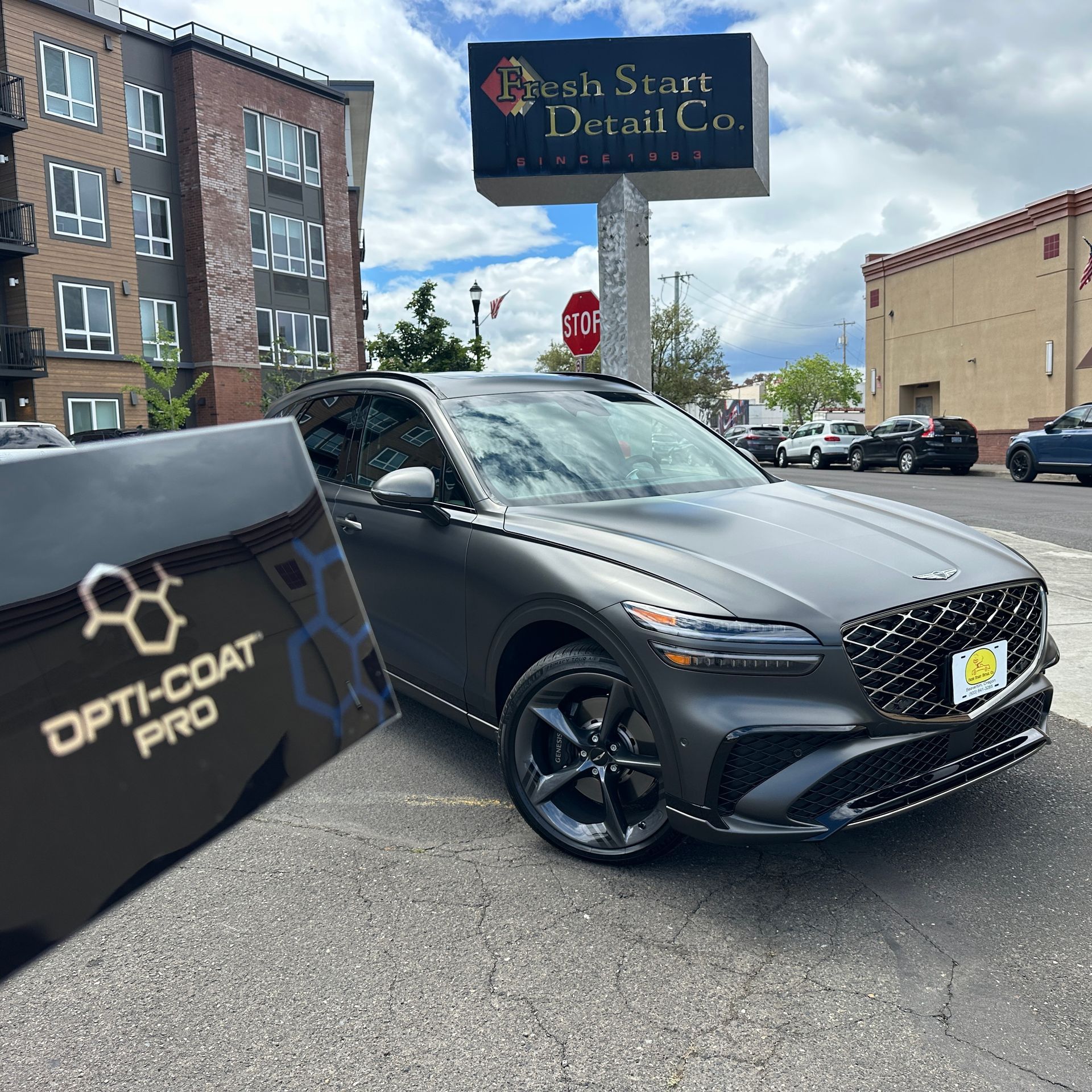 A box of Opti coat Pro in front of a matte satin painted Genesis car after being ceramic coated by Fresh Start Detail & Ceramic Coating in Beaverton.