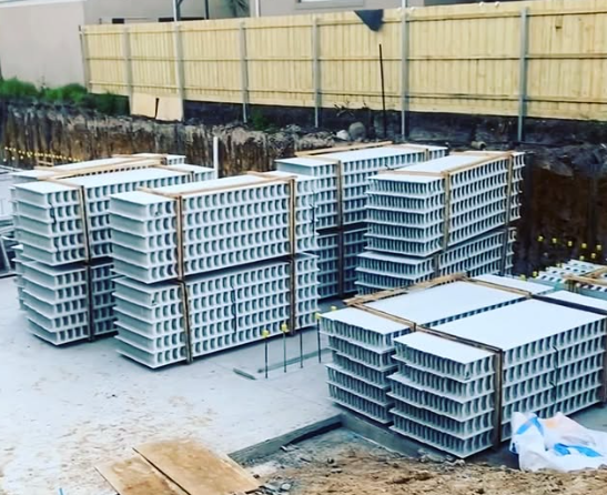A pile of concrete blocks stacked on top of each other on a construction site