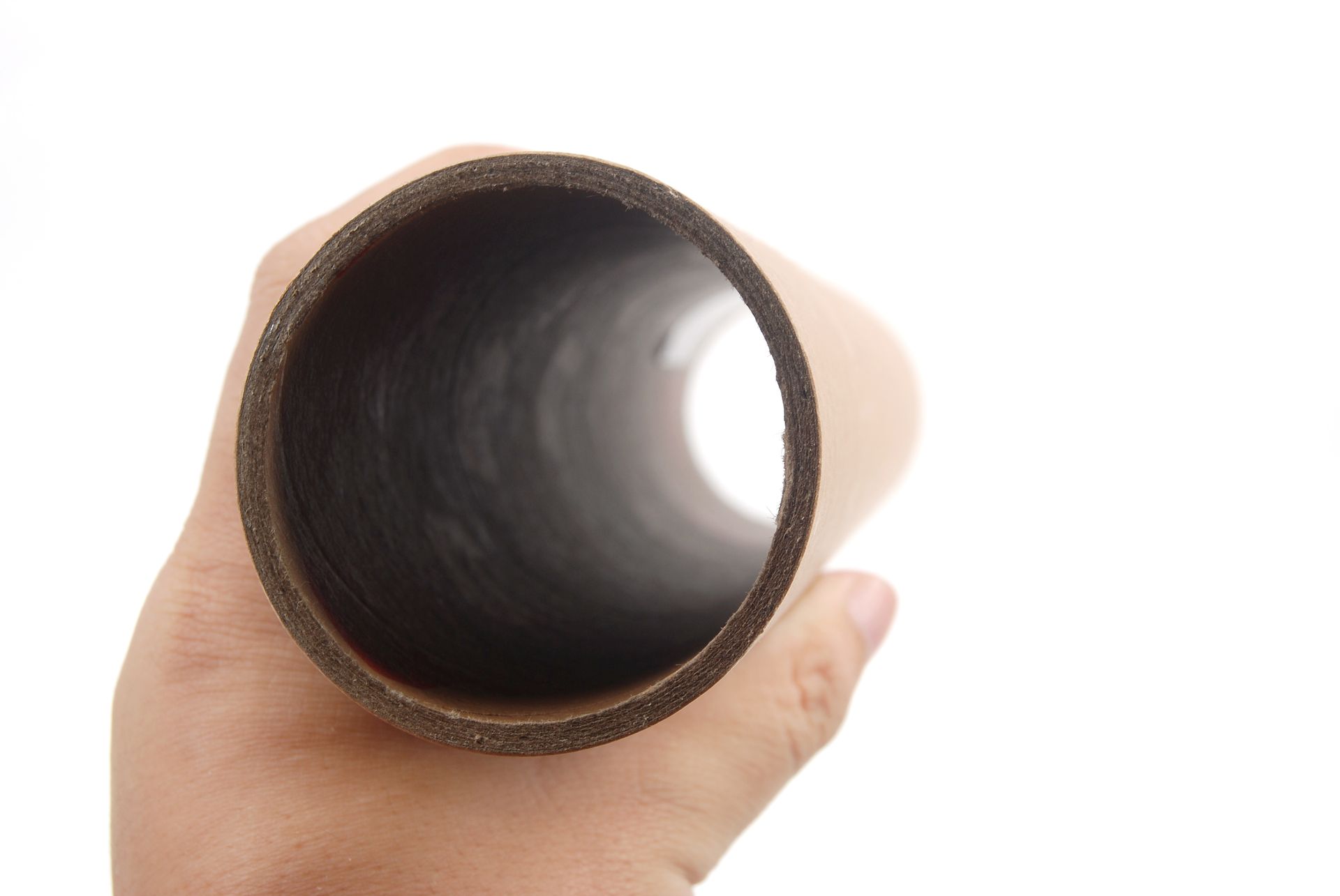 A close-up of a long cardboard cylinder being held by a hand on a white background.