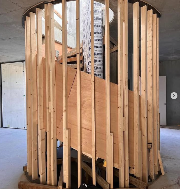 A wooden staircase is being built in a building
