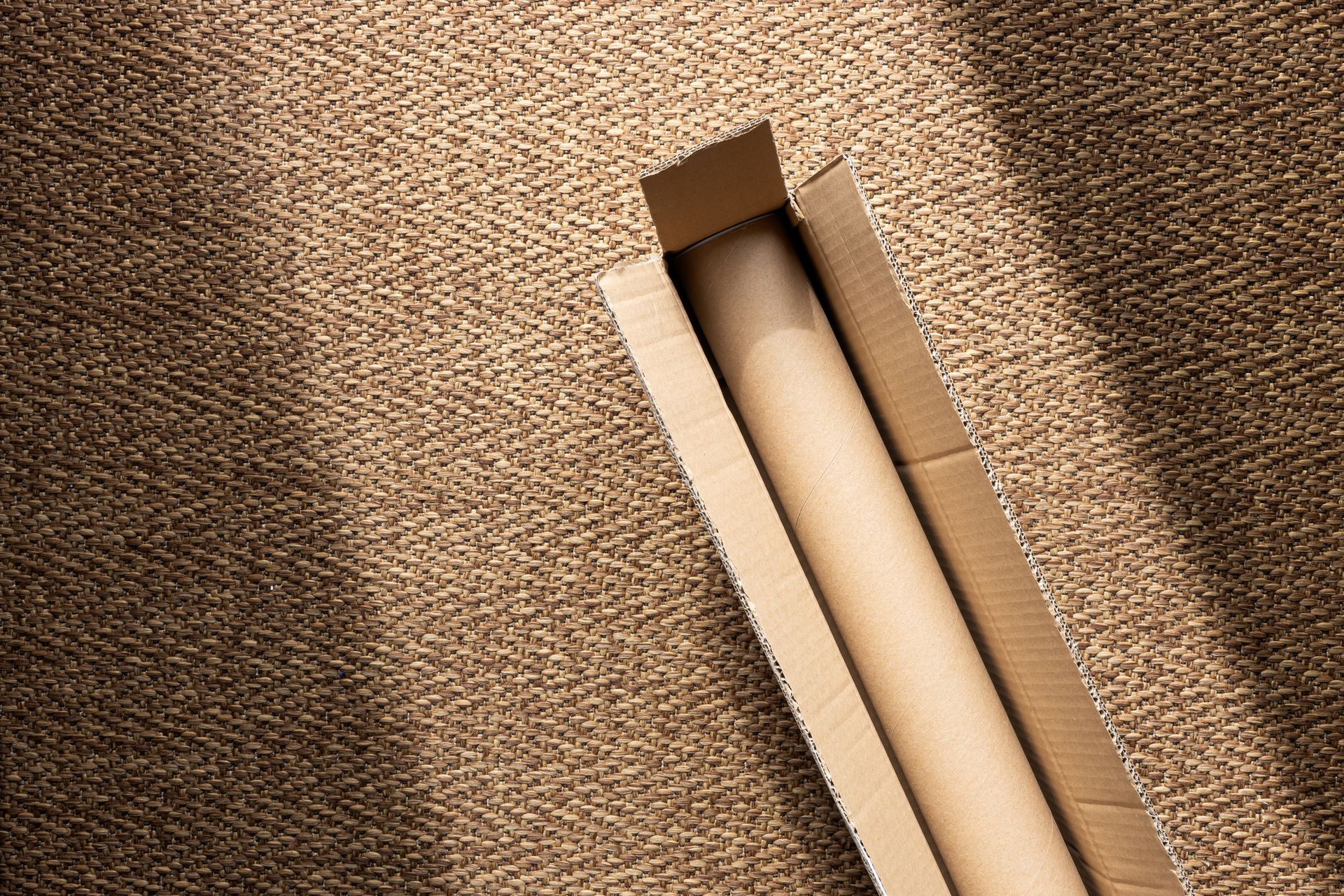 A cardboard mailing tube packaging, isolated on a white background A cardboard mailing tube packaging, isolated on a white background