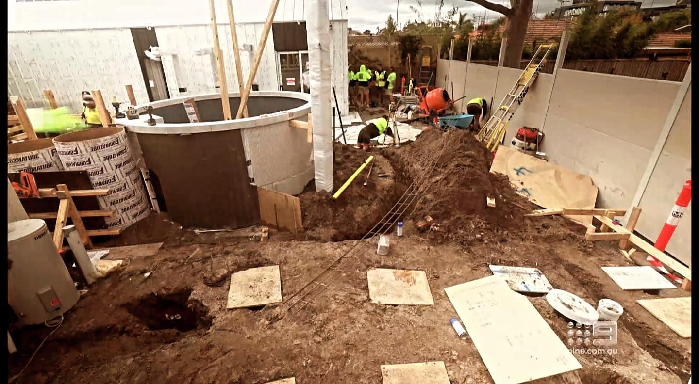 A group of construction workers are working on a construction site.
