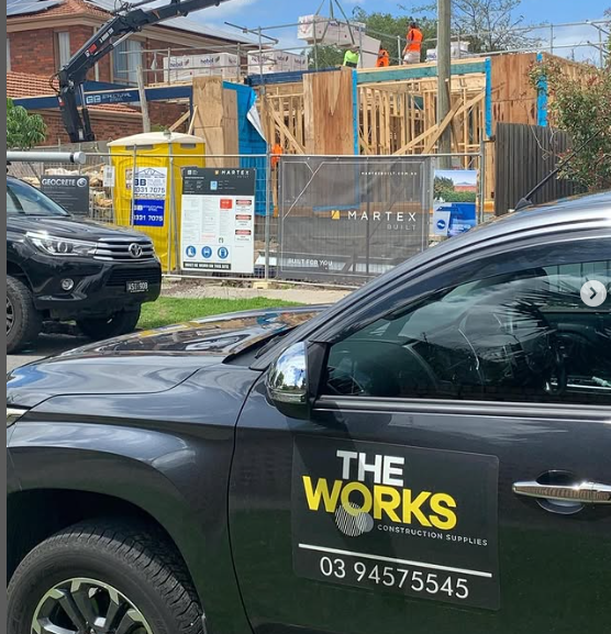 A black car with the words the works on the side