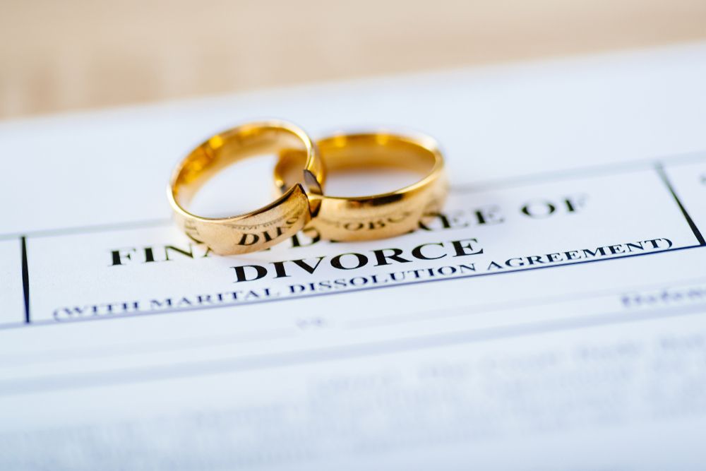 Two Gold Wedding Rings on a Divorce Document — Trapski Family Law Geelong in Newtown, VIC