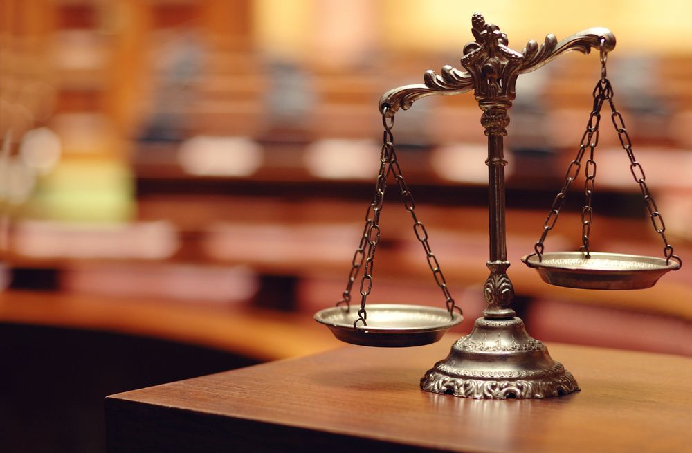 Scales of Justice on a Wooden Table, Courtroom Background — Trapski Family Law Geelong in Newtown, VIC