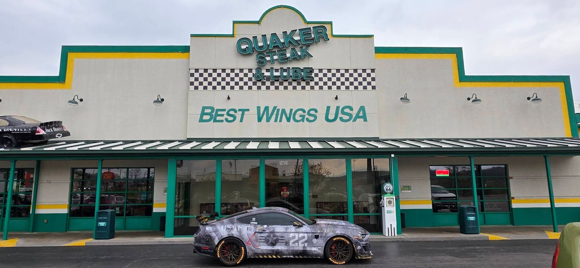 Best Wings USA storefront with a parked car in front