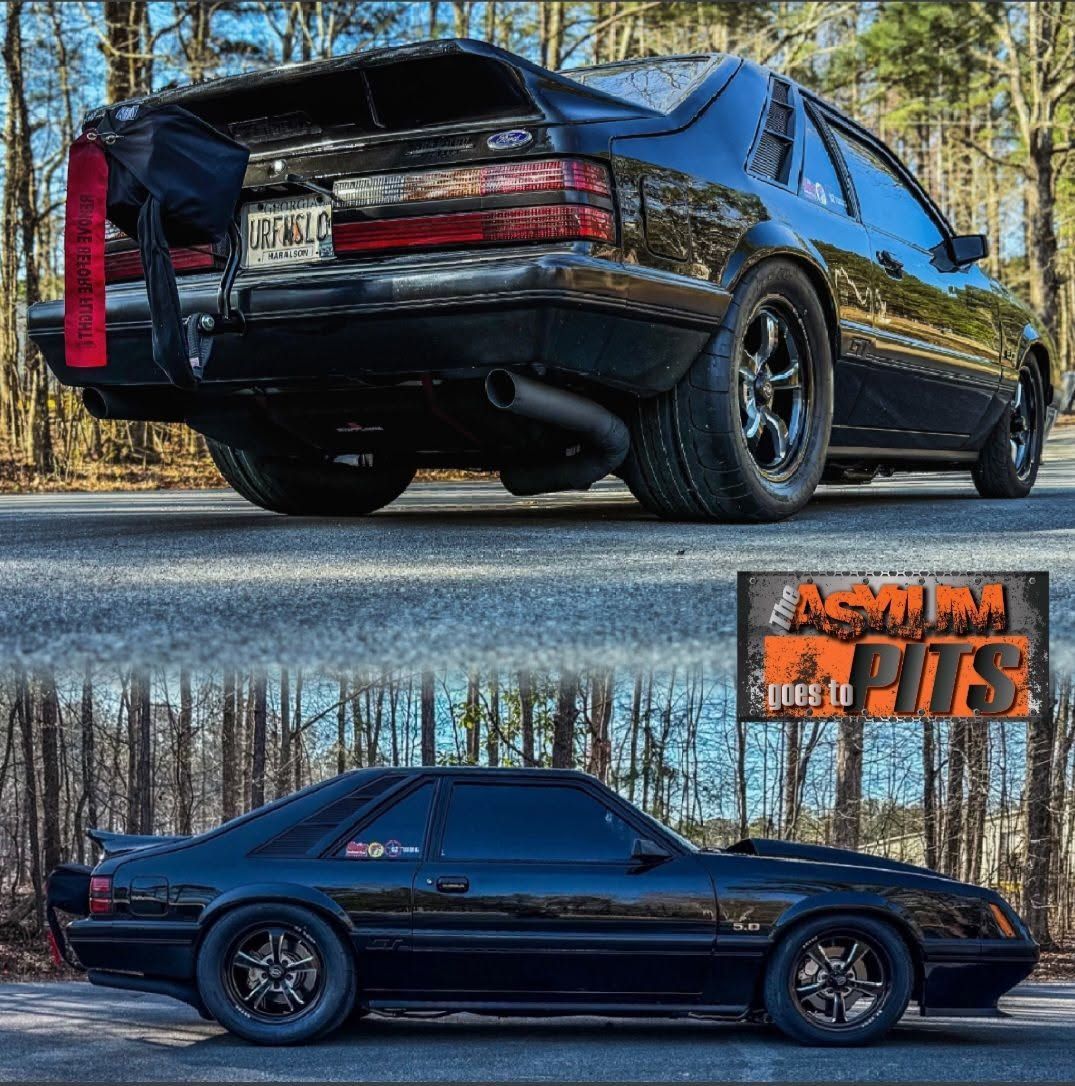 Black modified coupe shown in two side-view photos, glossy paint, black wheels, wooded roadside setting