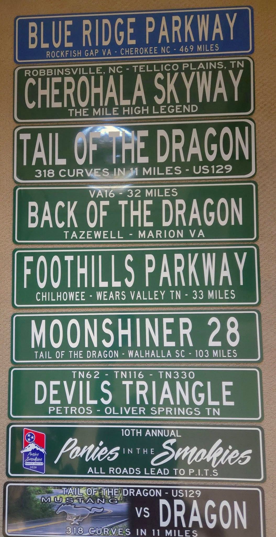 Stack of colorful roadside signs for the Blue Ridge Parkway and nearby attractions.