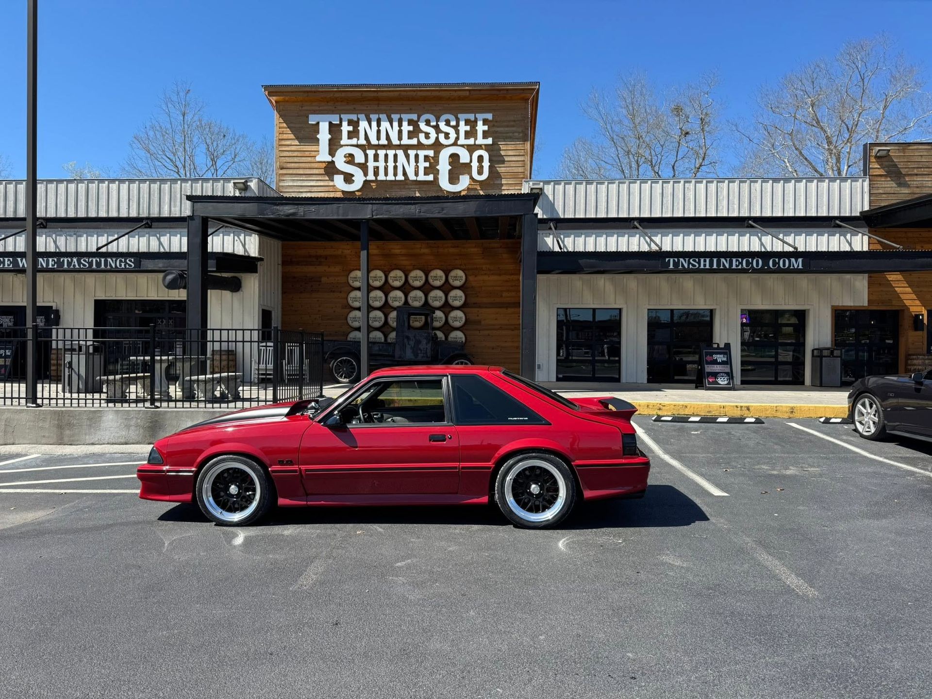Red sports car parked in front of the Tennessee Stone Co. building