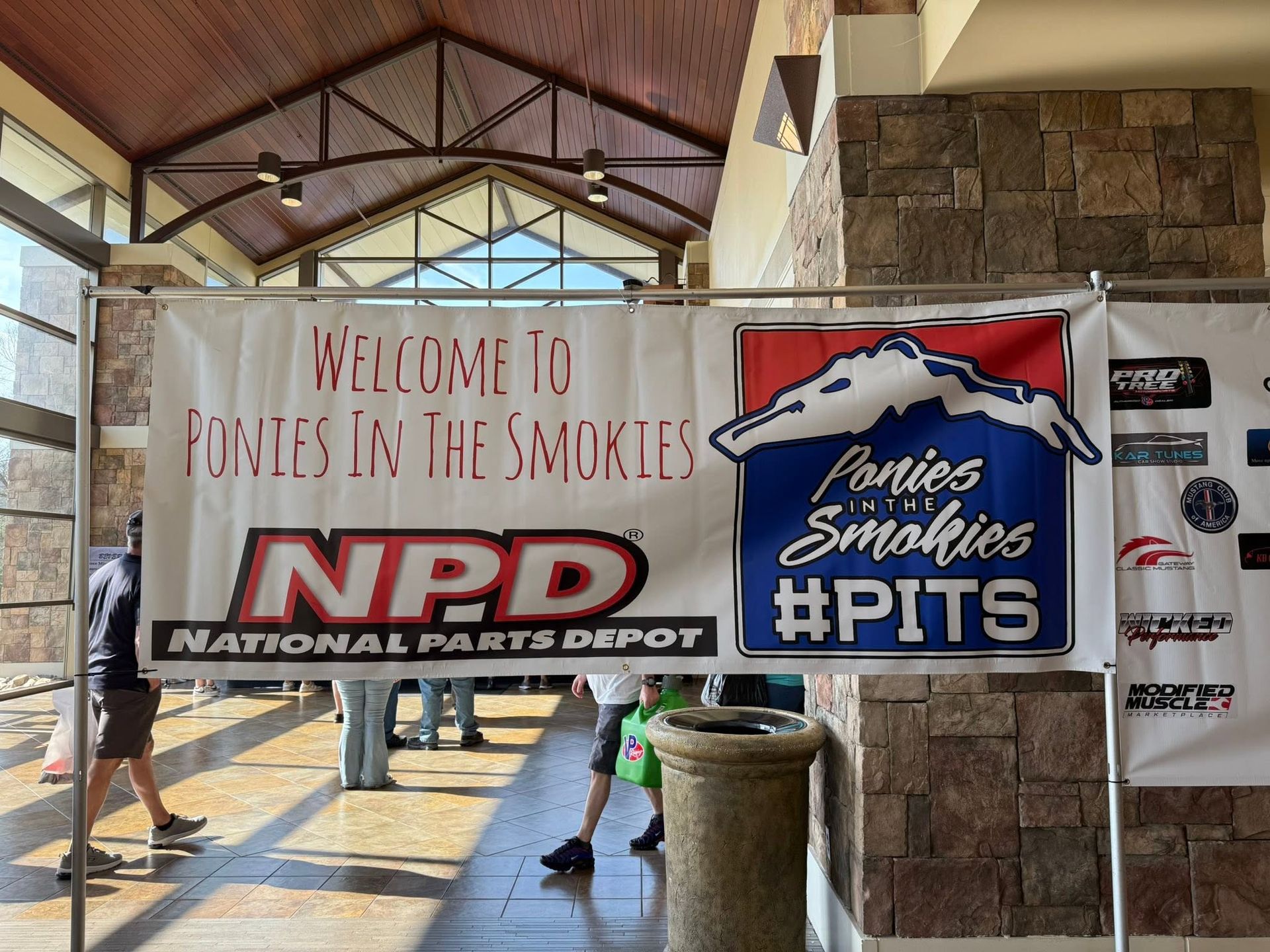 Welcome sign at Ponte Vedra NPD with Colorado Rockies-inspired Pits banner in a covered walkway