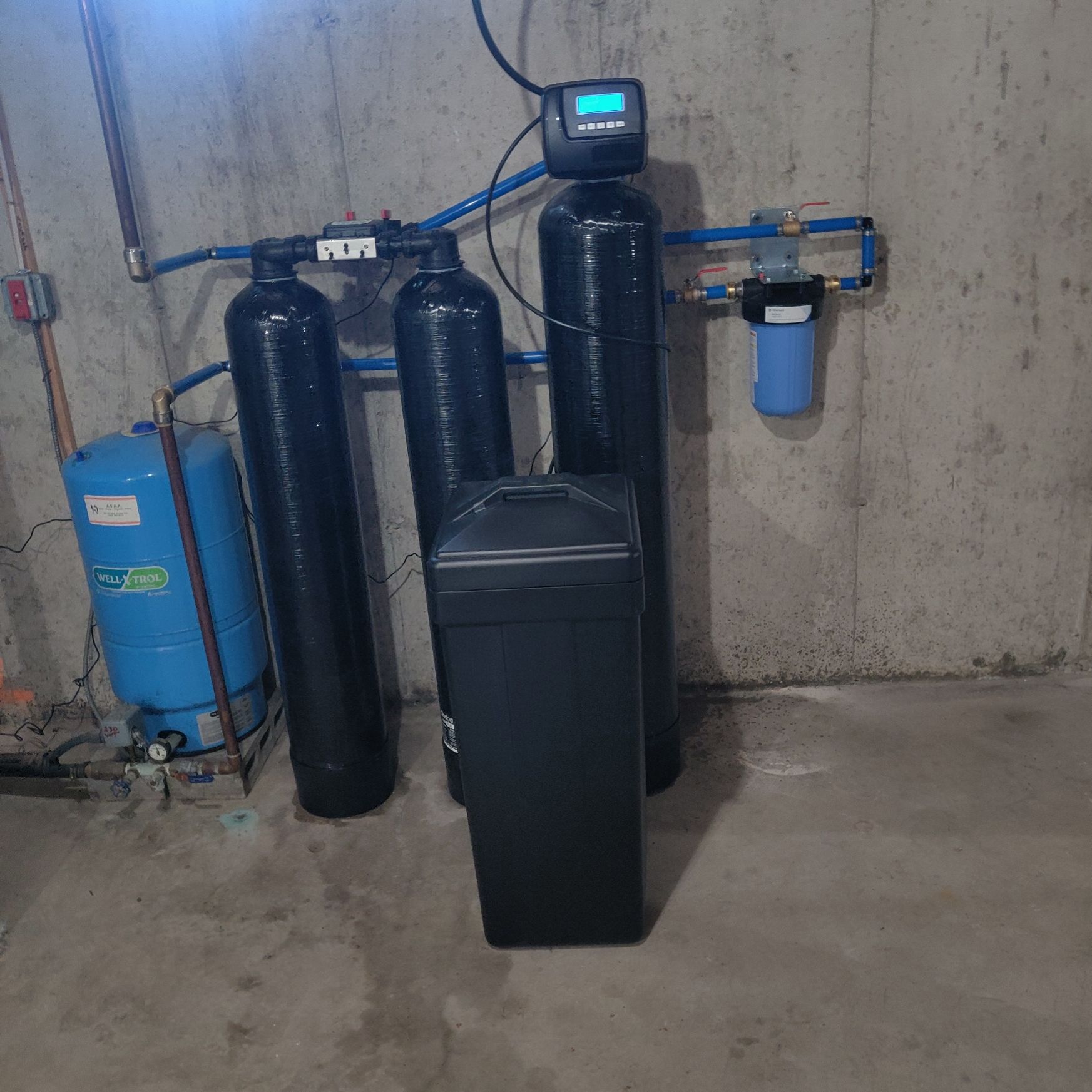 A water treatment system is installed in a basement.