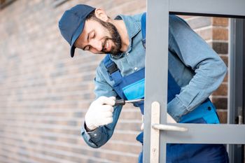 Repairing entrance door of a new house outdoors