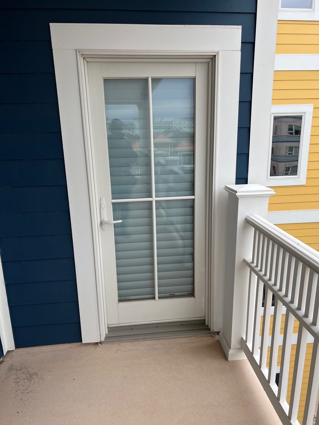 A blue and yellow house with a white door