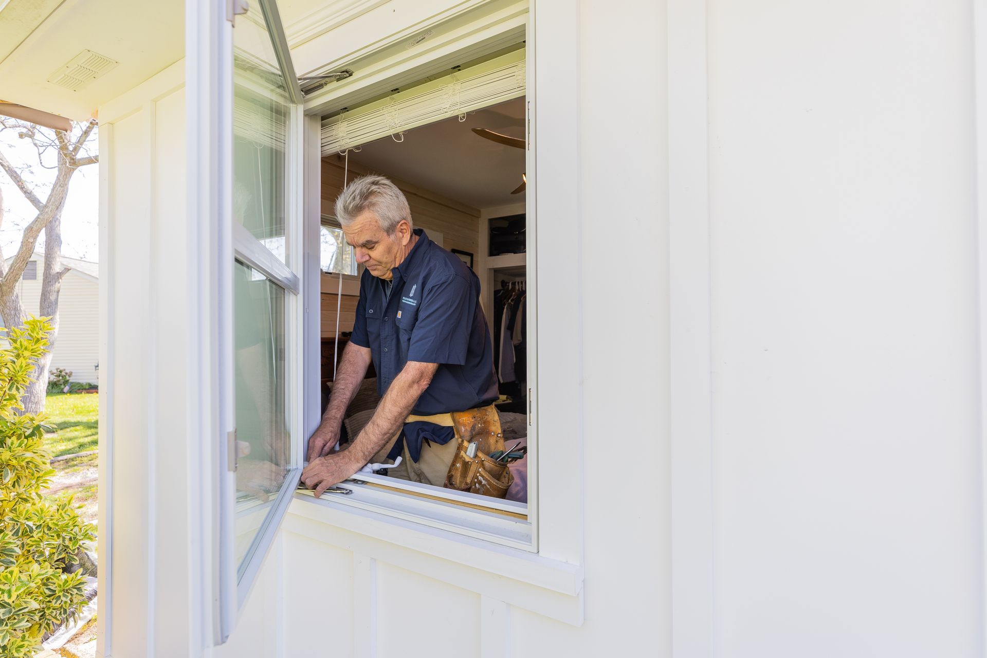 Worker installing new window in house