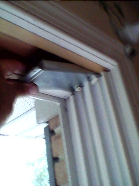 Worker installing new window in house