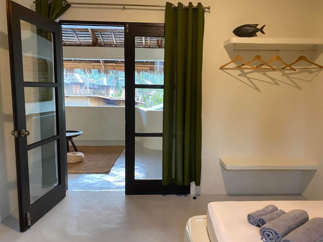 A bedroom with a sliding glass door leading to a balcony