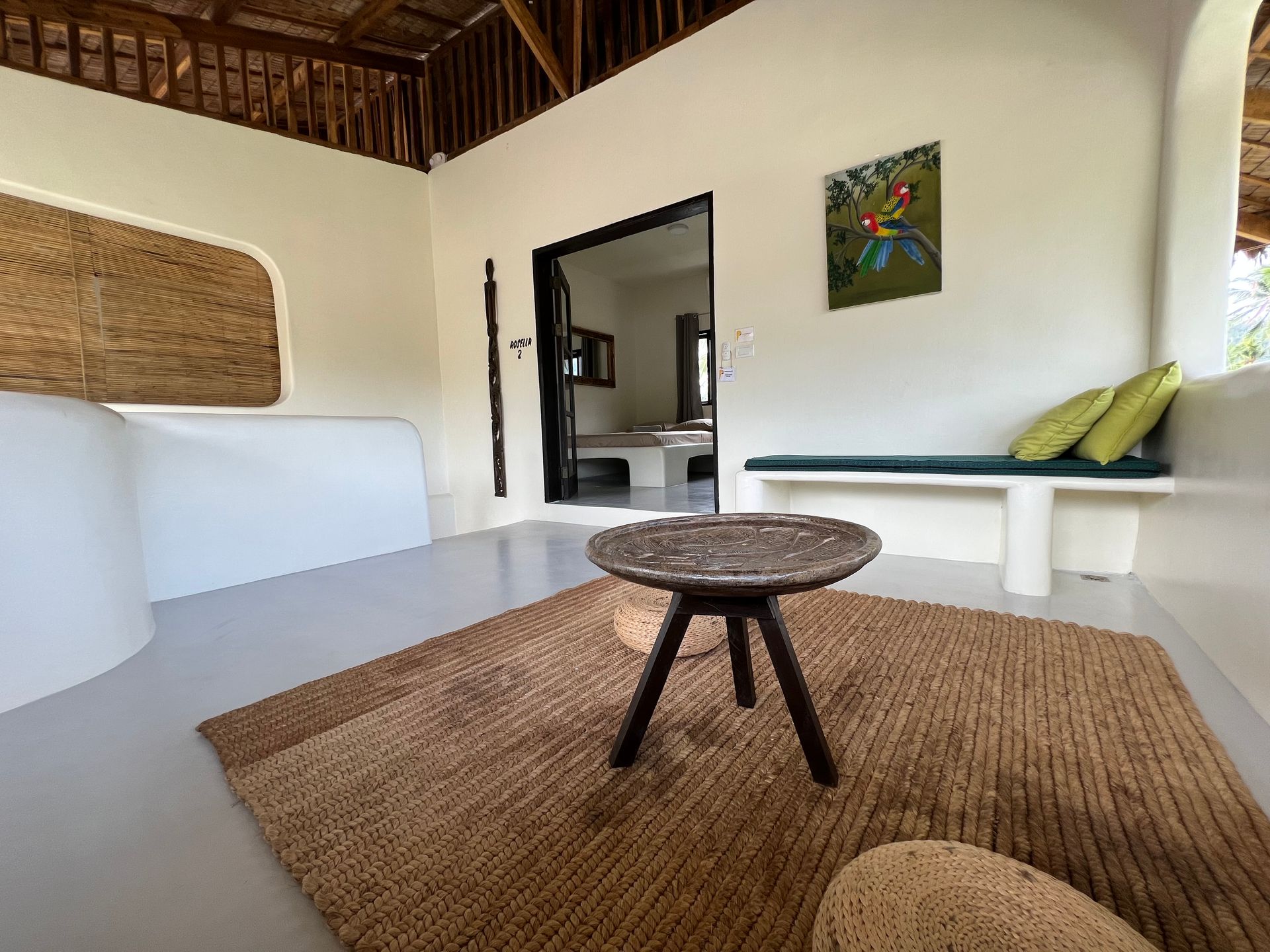 A living room with a couch , table and rug.