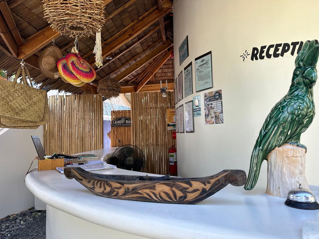 A statue of a bird is sitting on a counter in a reception area.