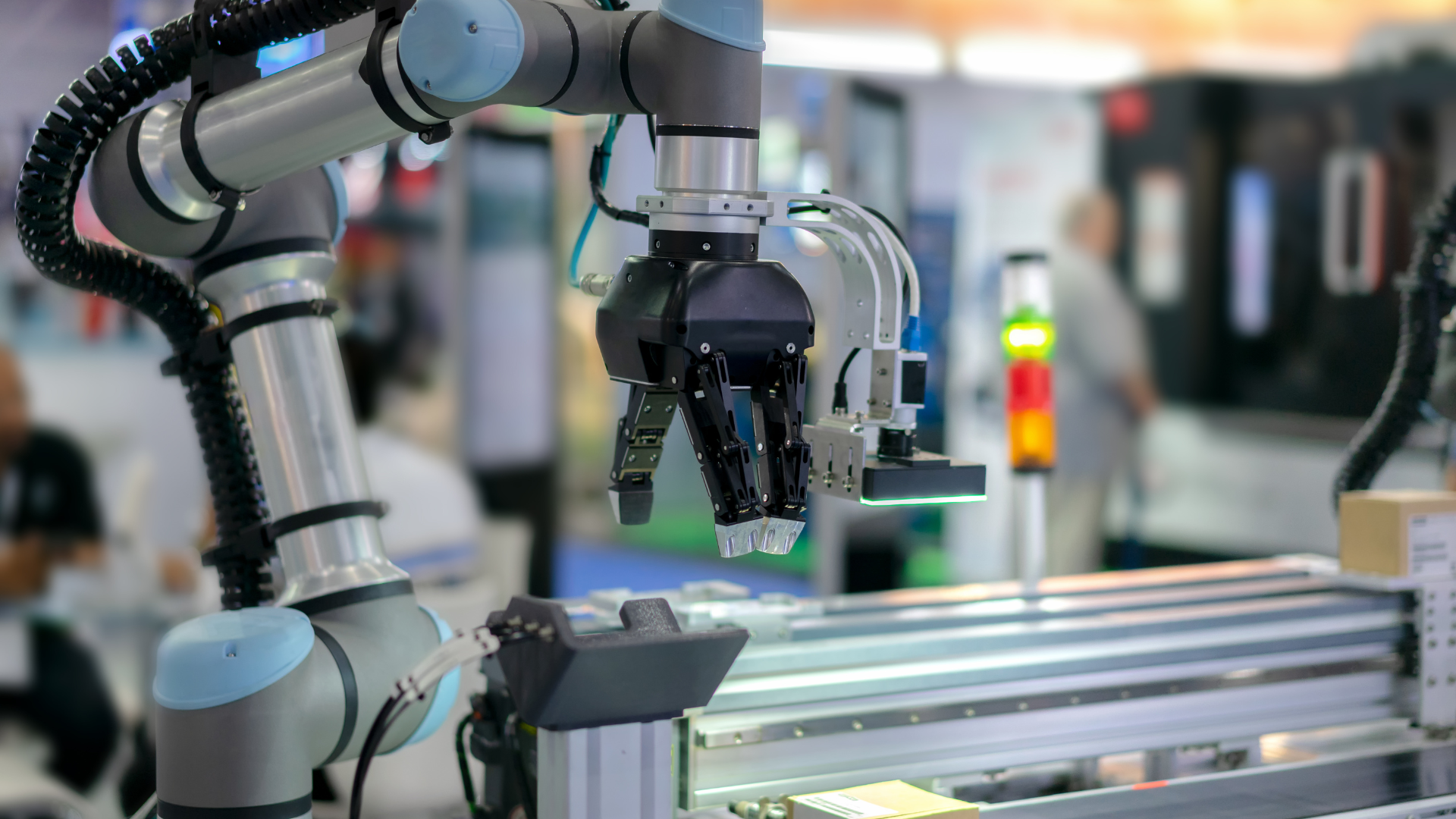 A robotic arm is working on a machine in a factory.