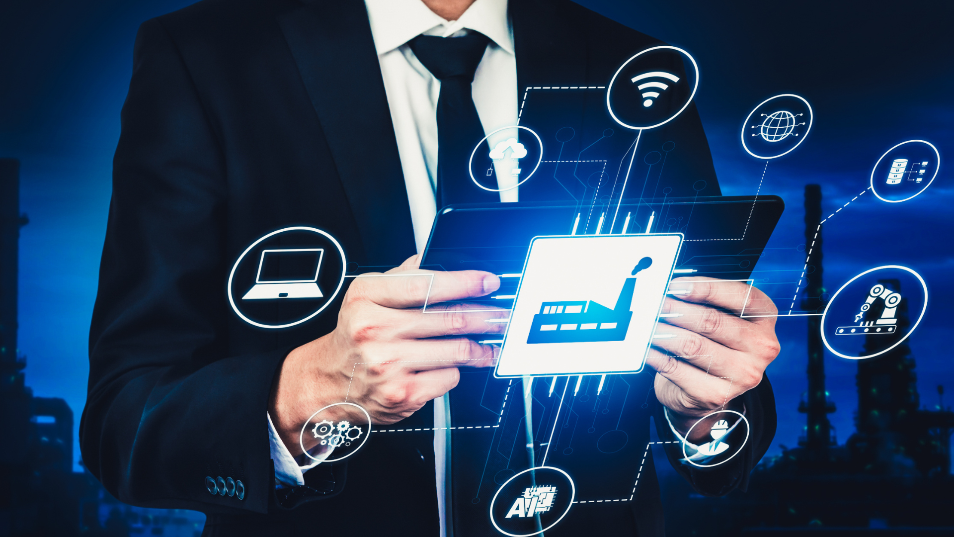 A man in a suit and tie is holding a tablet in his hands.