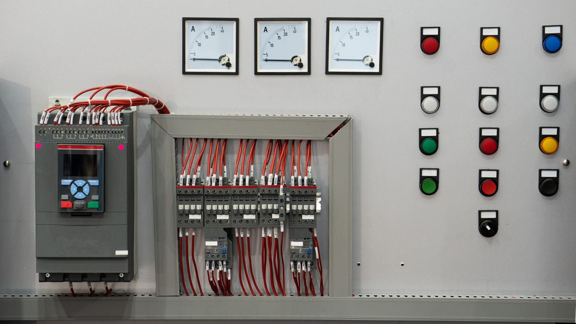 A control panel with a lot of wires and electrical equipment on it