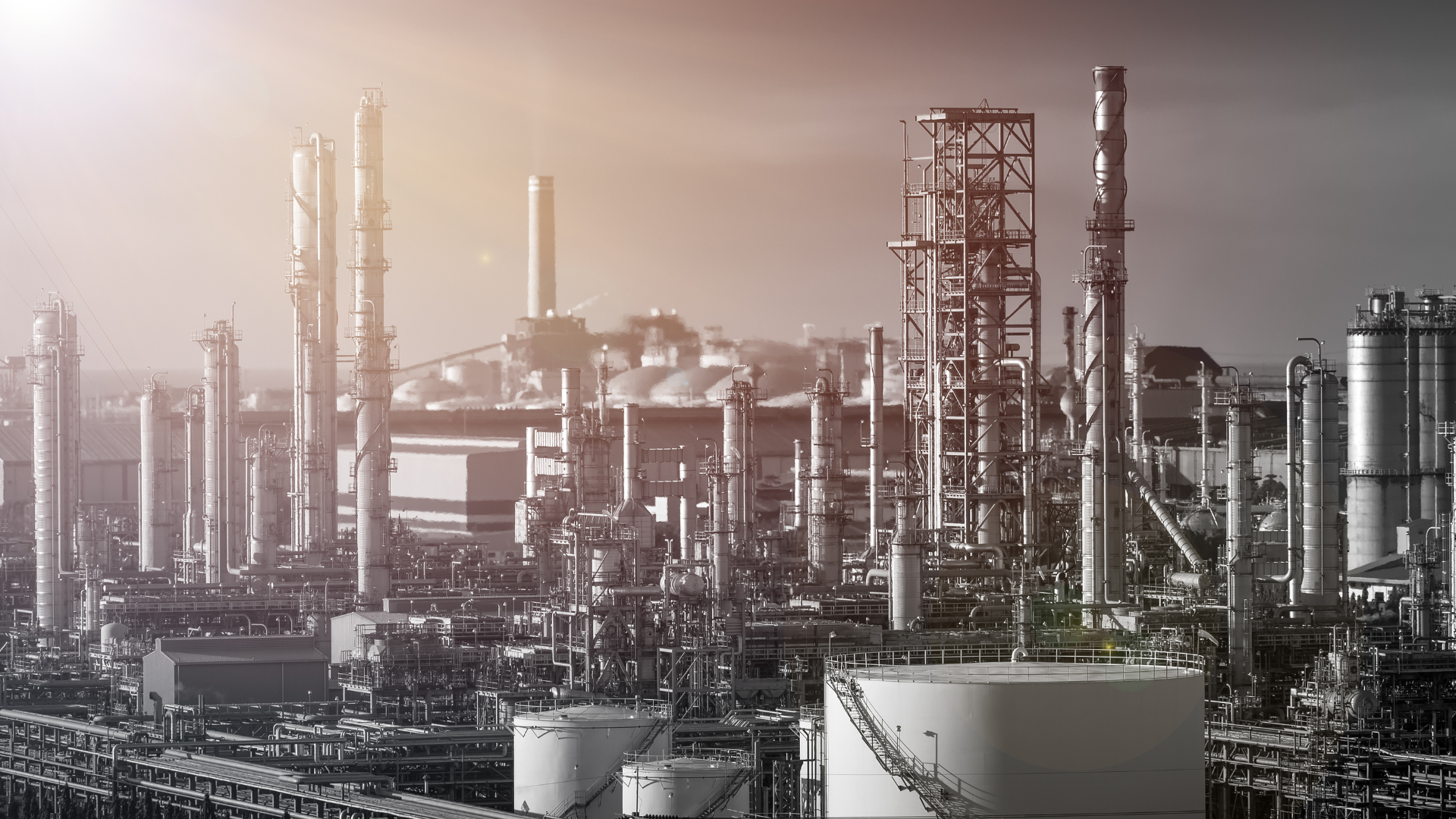 It is a black and white photo of a large oil refinery.