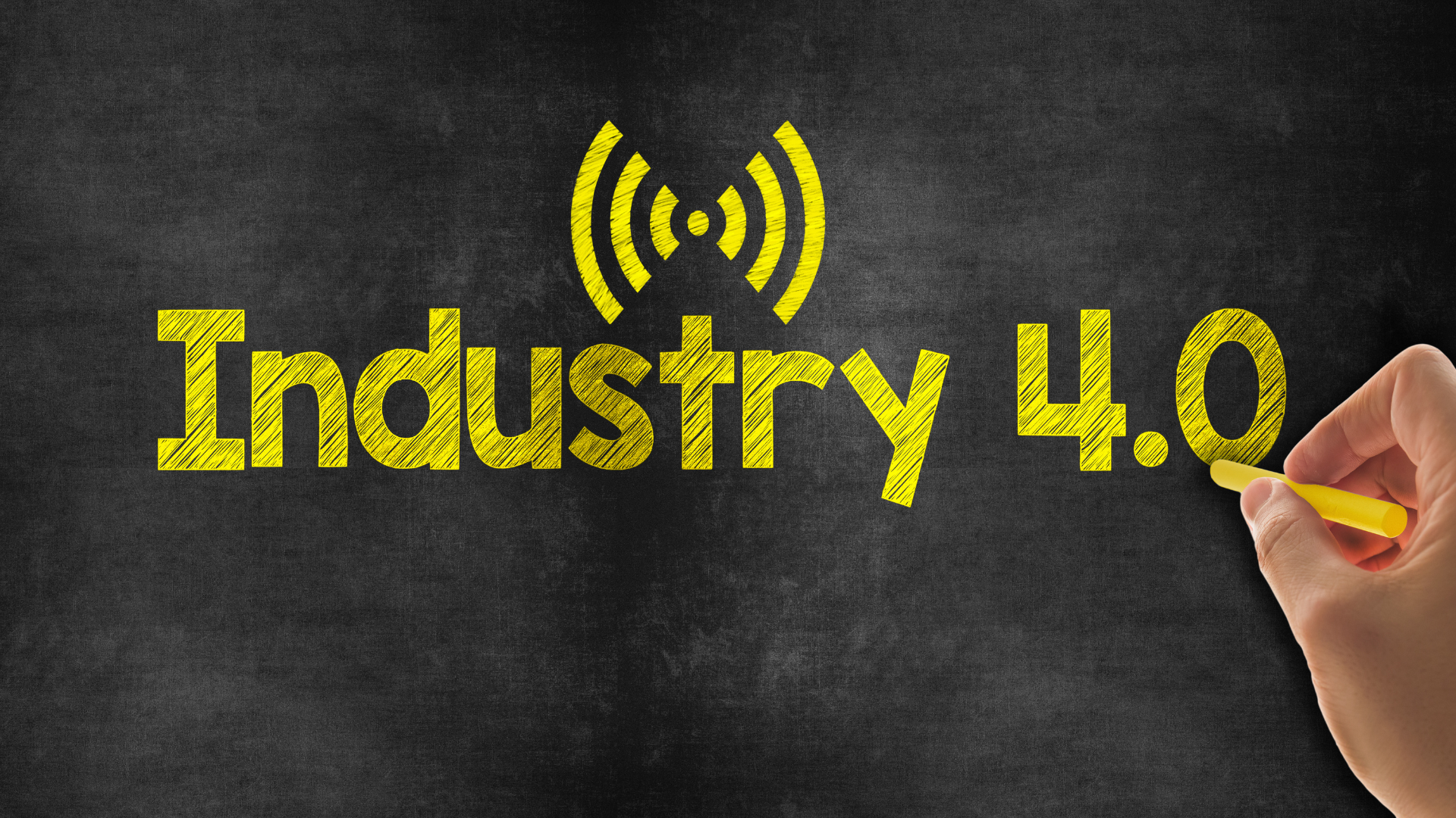 A person is writing the word industry 4.0 on a blackboard