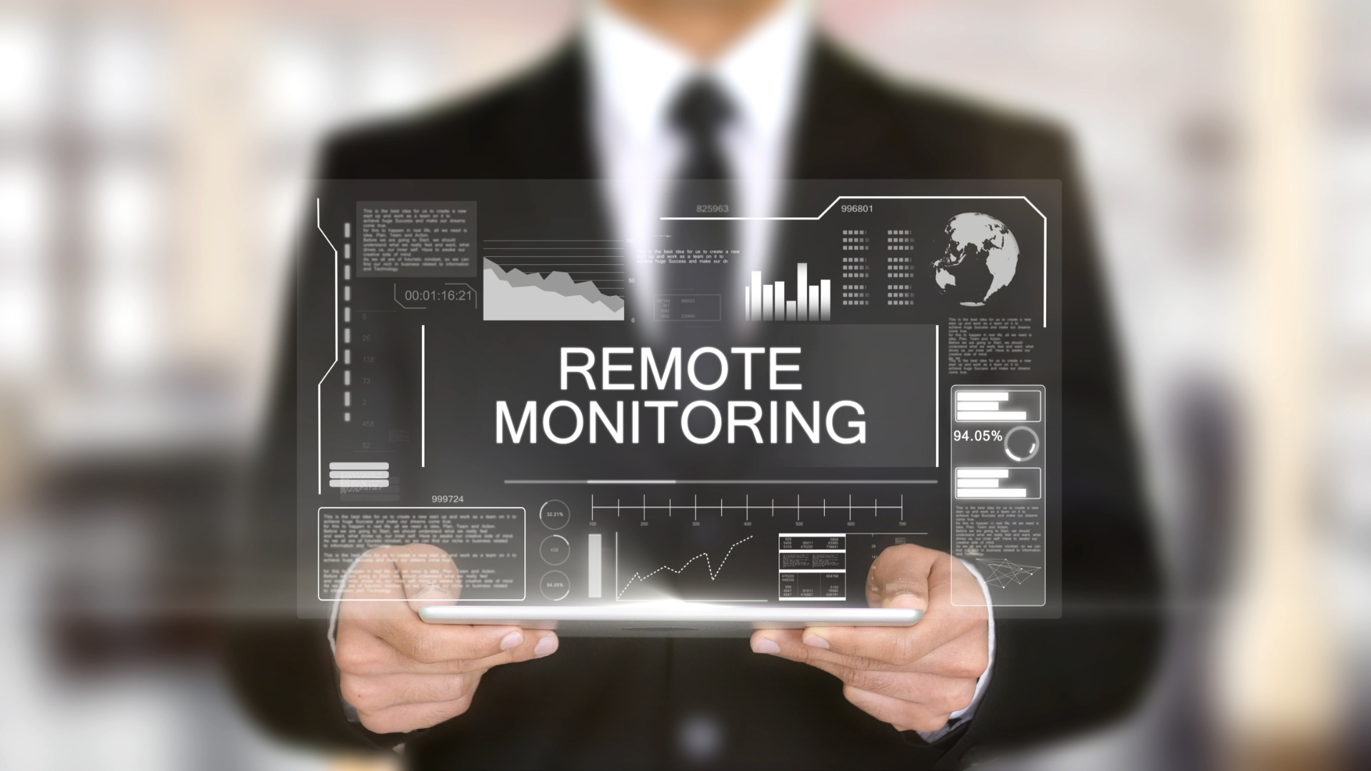 A man in a suit is holding a tablet with the words remote monitoring on it.