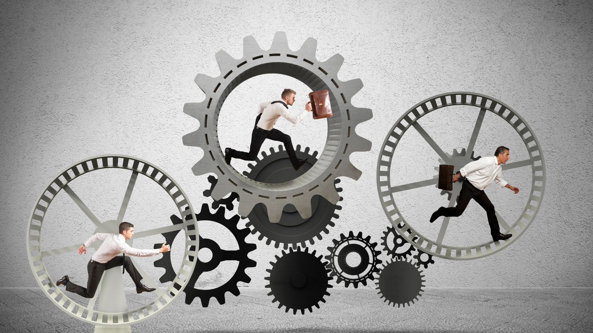 A group of men are running through gears on a wall.