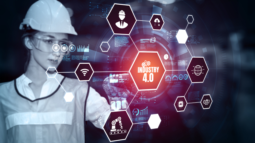 Engineer in hard hat viewing Industry 4.0 digital interface with glowing icons and data graphics