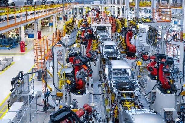 A factory filled with lots of robots making cars.