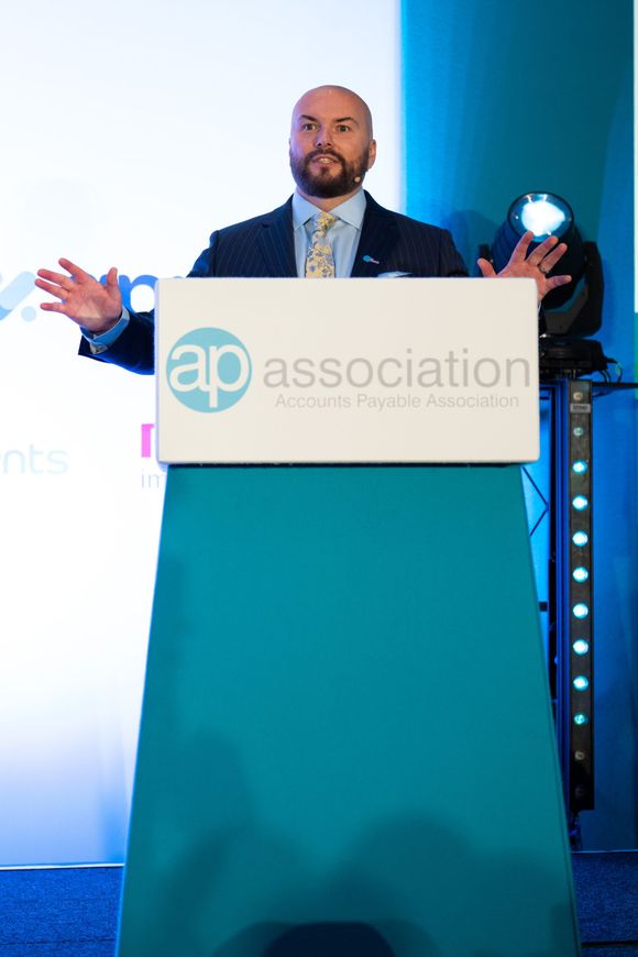 A man is giving a speech at a podium that says ap association