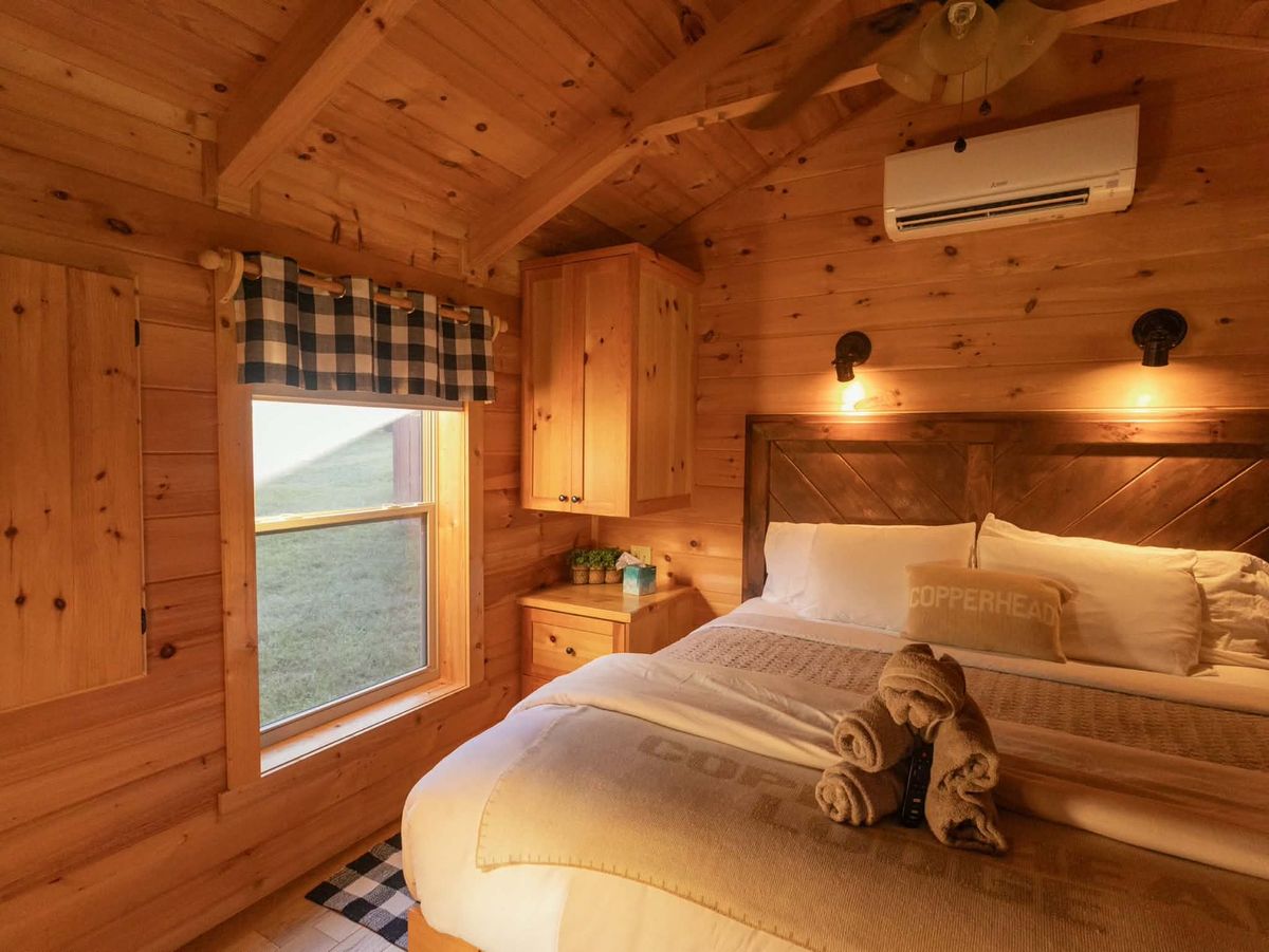 Cabin bedroom interior with neatly made bed