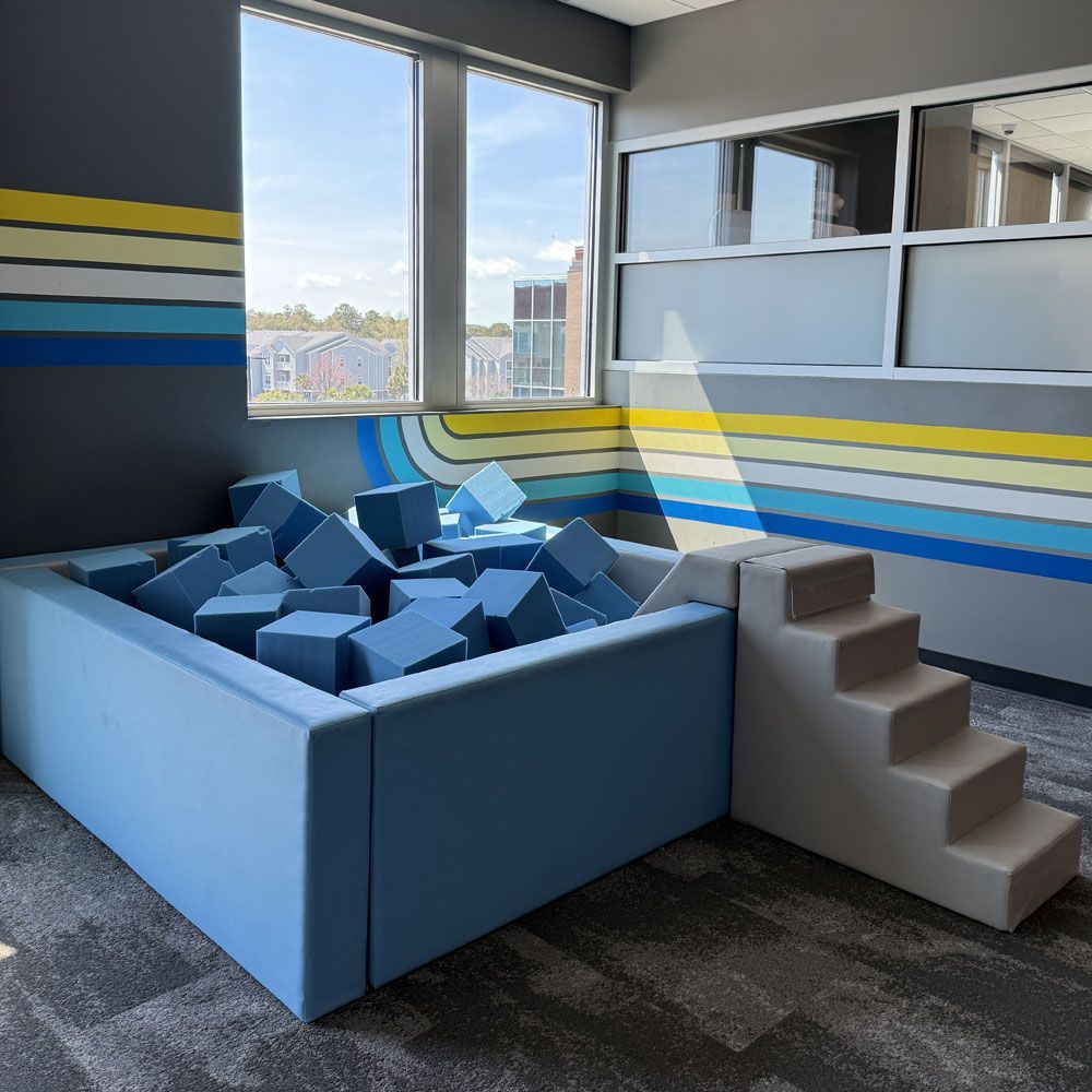 A room with a foam ball pit and stairs.