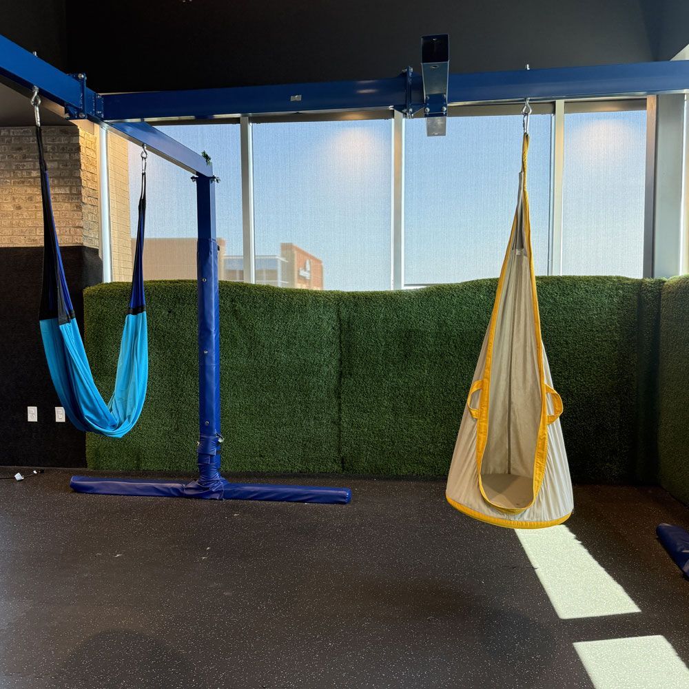 A room with two hammocks hanging from the ceiling