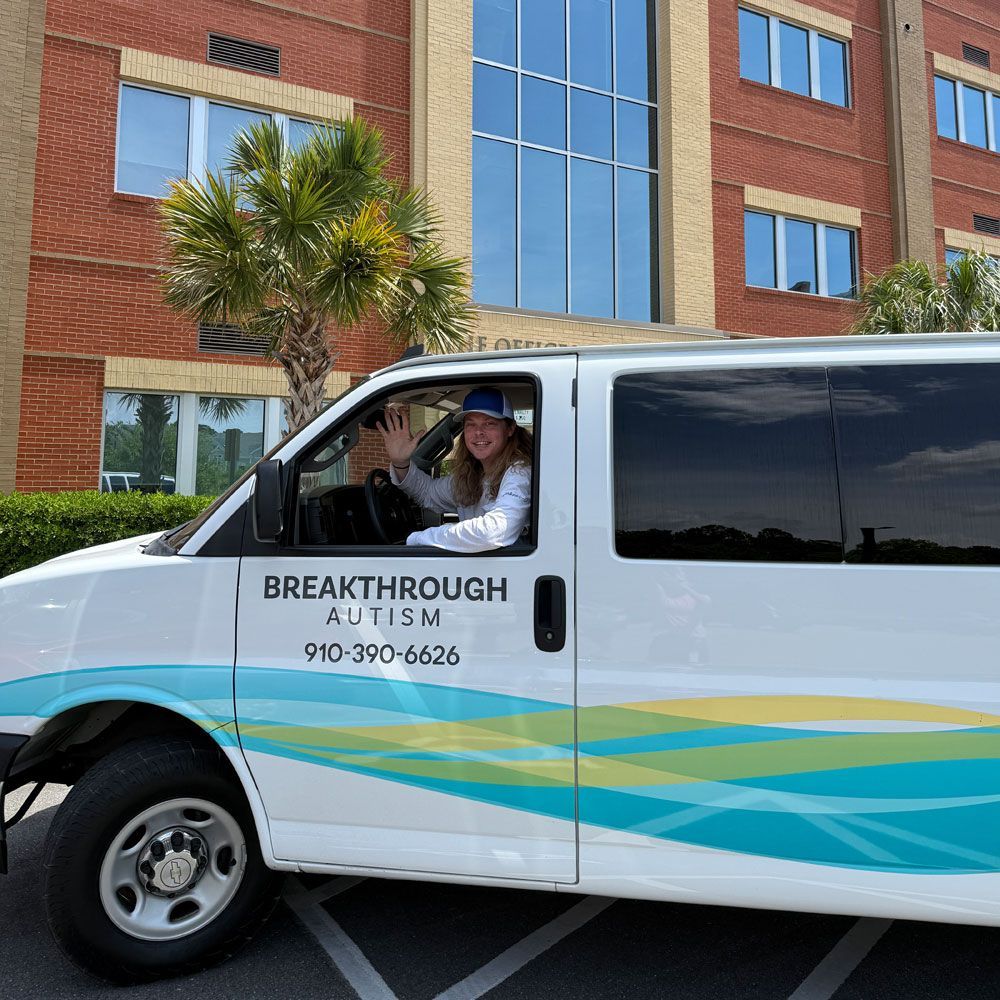 A breakthrough autism van is parked in front of a building