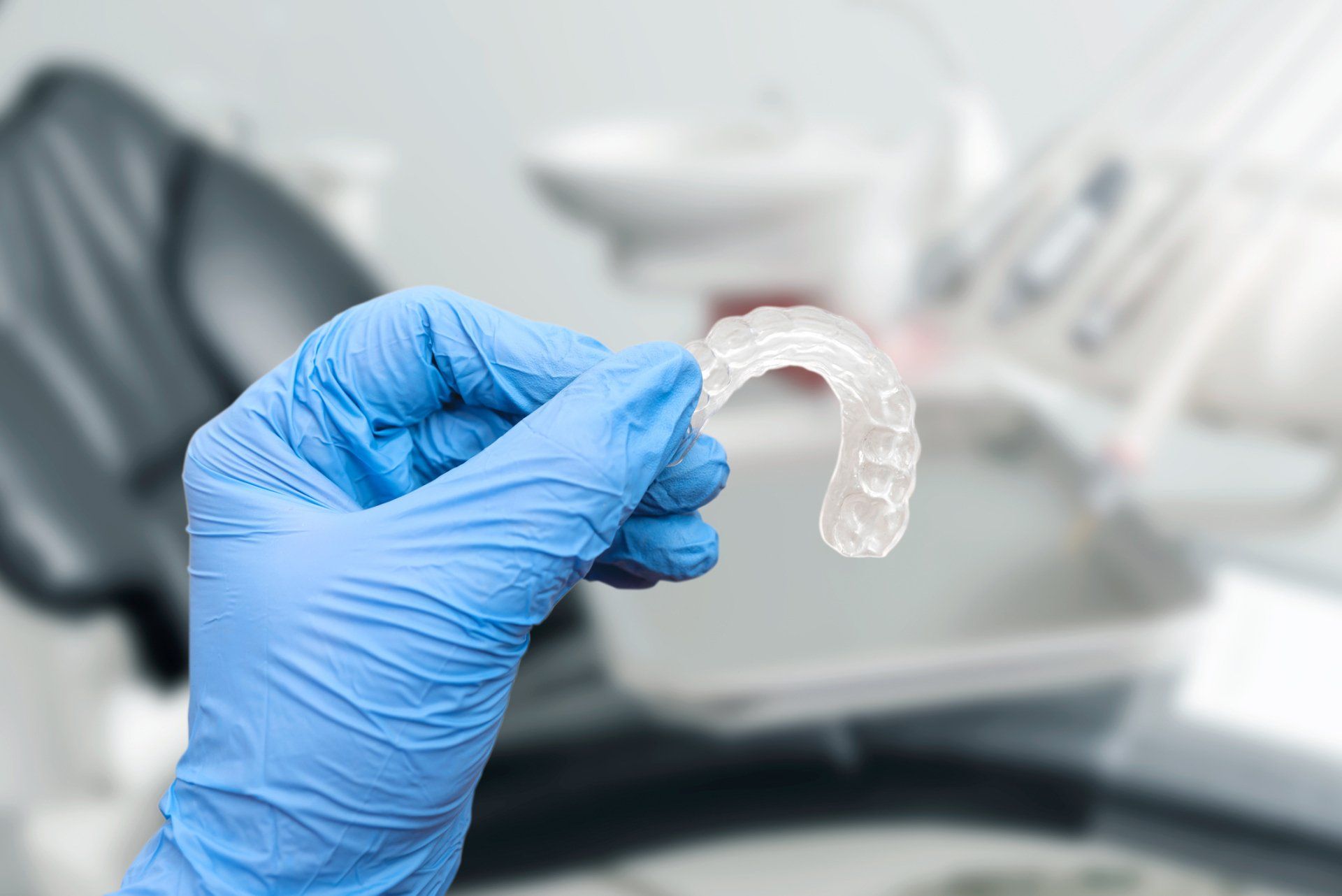 close up of woman about to place invisalign