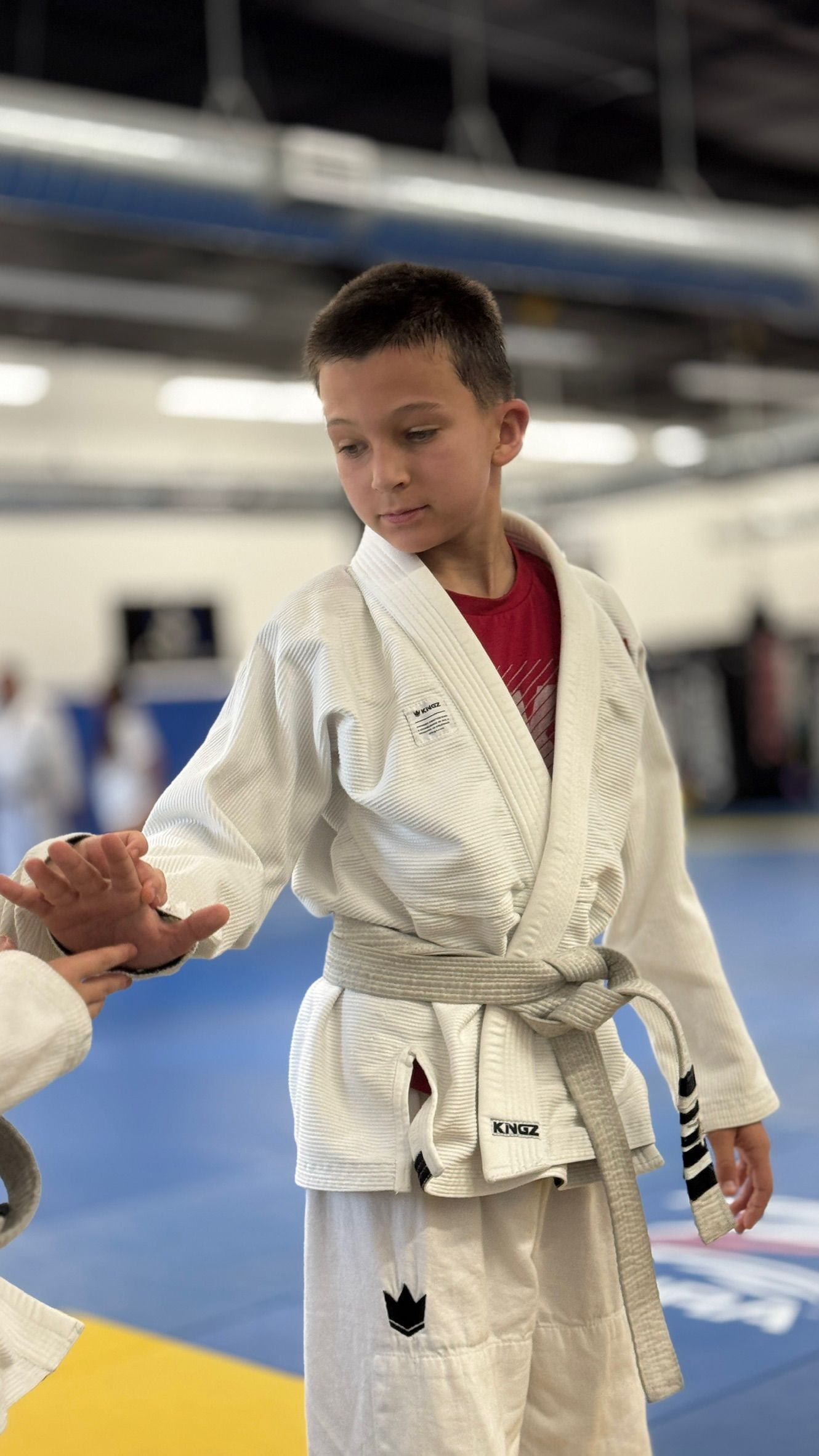 Kids and adults drilling Brazilian Jiu-Jitsu at Tetris Jiu-Jitsu in Orlando, FL, building fitness.