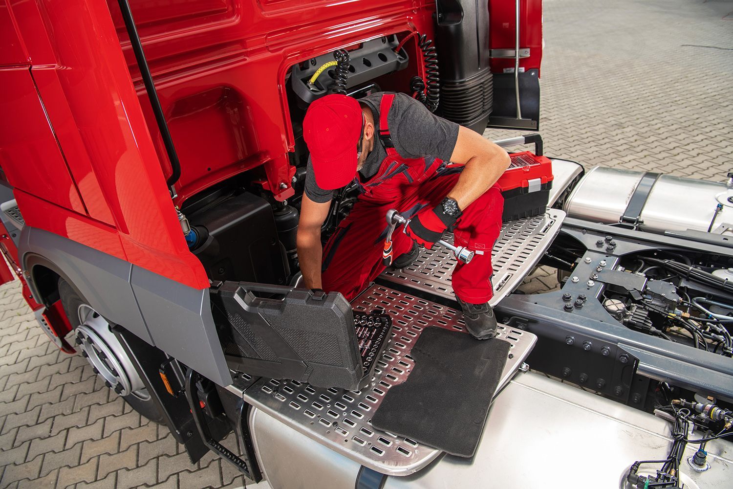 The mechanic carefully prepares tools, getting ready to begin essential truck repair work.