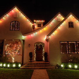 House decorated with colorful Christmas lights at night