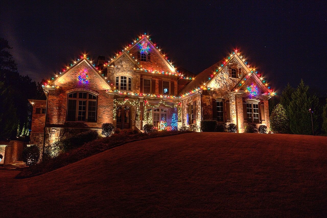 House decorated with colorful Christmas lights at night
