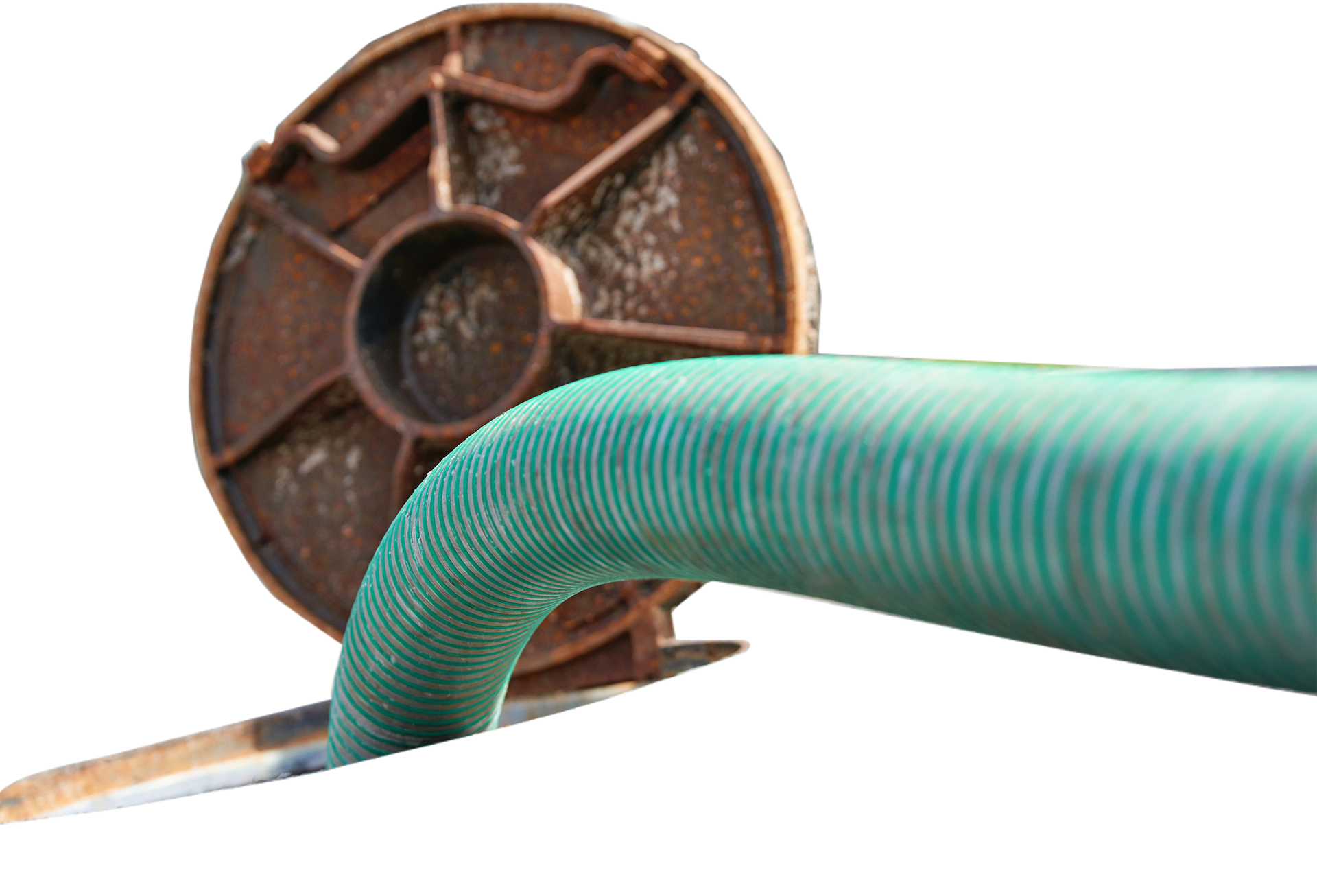 Rusty spool with a green hose extending from it.