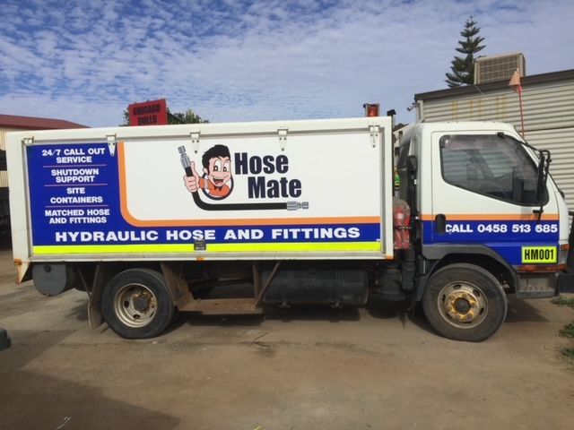A hose mate truck is parked in a parking lot