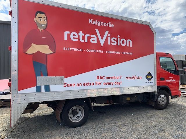 A red truck with the word retravision on the side